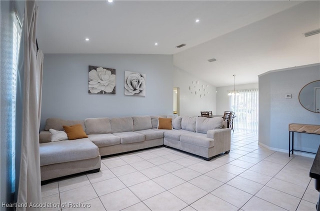 tiled living room with a chandelier and vaulted ceiling