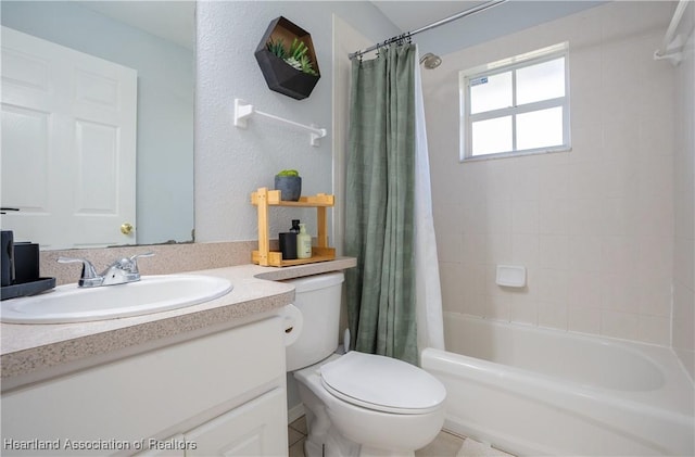 full bathroom with vanity, shower / tub combo, and toilet