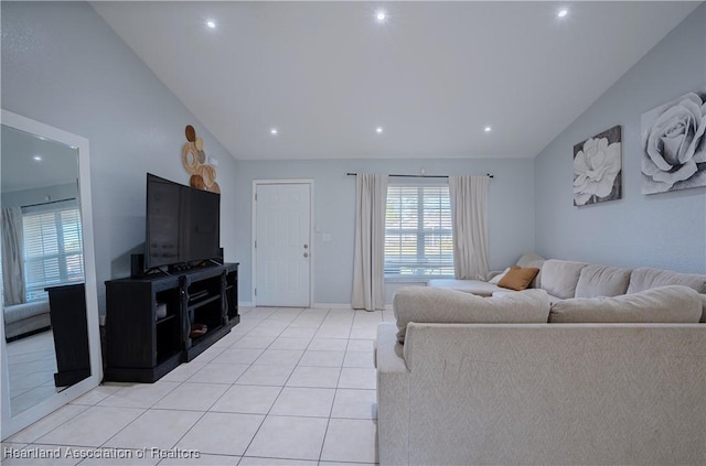 living room featuring light tile patterned floors and vaulted ceiling