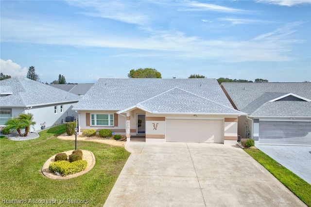 single story home featuring a garage and a front lawn