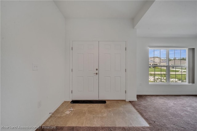 view of carpeted entrance foyer