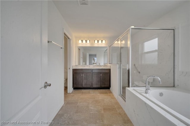 full bathroom featuring vanity, separate shower and tub, and toilet