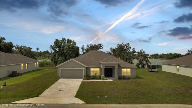 view of front of home featuring a lawn and a garage