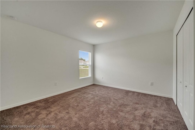 unfurnished bedroom featuring carpet and a closet