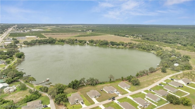 birds eye view of property with a water view