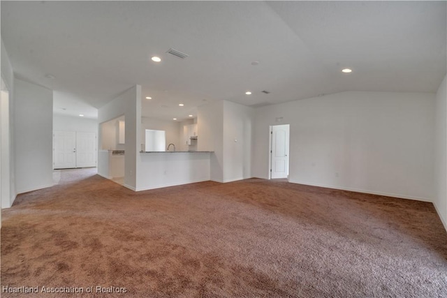 unfurnished living room featuring light carpet