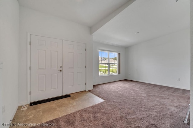 entrance foyer featuring light colored carpet