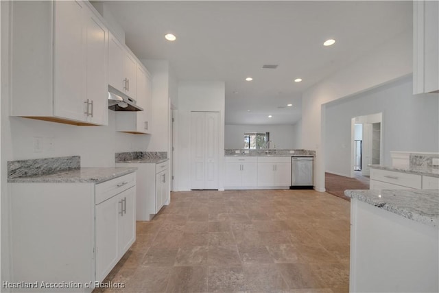 kitchen with white cabinetry, sink, stainless steel dishwasher, and light stone counters