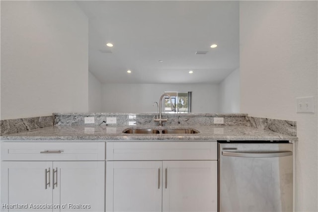 kitchen with white cabinetry, dishwasher, light stone countertops, and sink