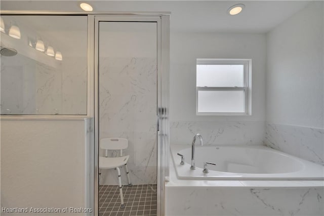 bathroom featuring shower with separate bathtub