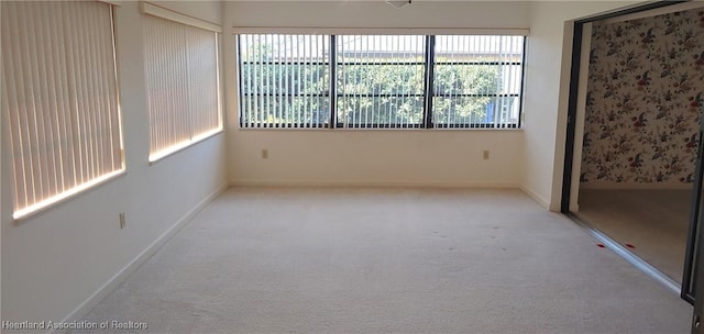 carpeted empty room featuring plenty of natural light