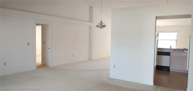 carpeted spare room featuring sink