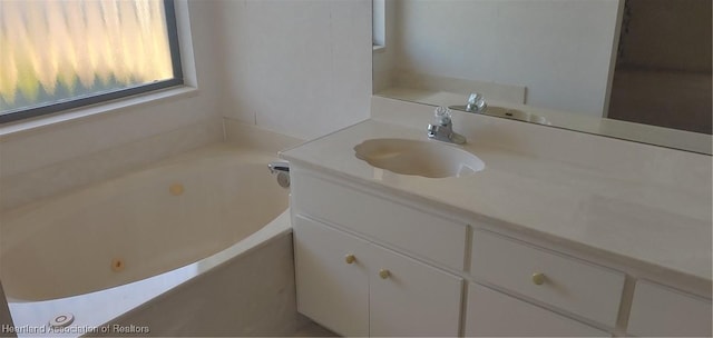 bathroom with vanity and a washtub