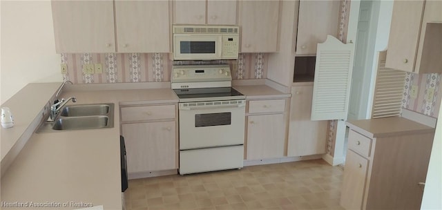 kitchen featuring sink and white appliances