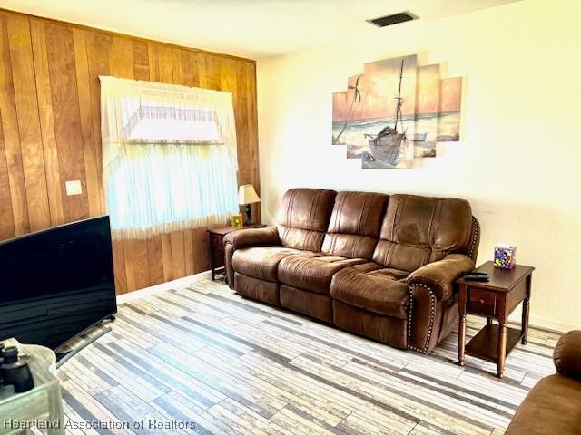 living room featuring wood walls