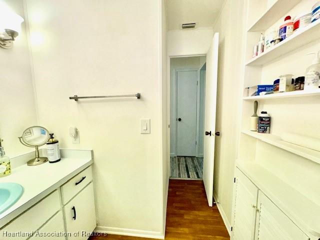 bathroom with hardwood / wood-style floors and vanity