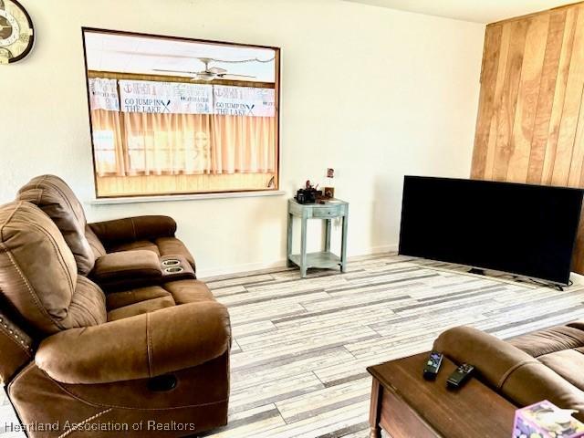 living room featuring hardwood / wood-style flooring and ceiling fan