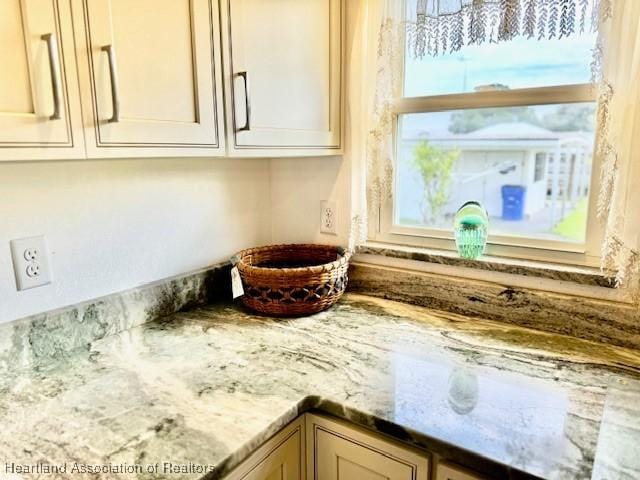 interior details with light stone counters and cream cabinets