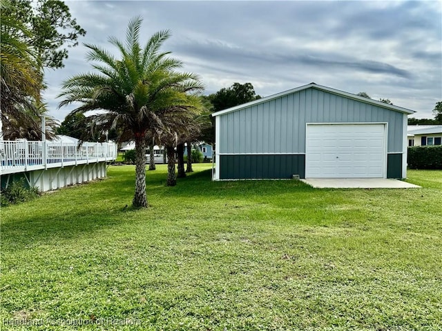 view of yard featuring a garage and an outbuilding