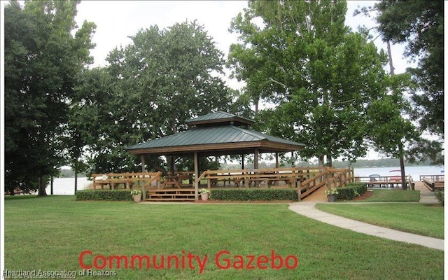 view of home's community with a gazebo, a lawn, and a water view