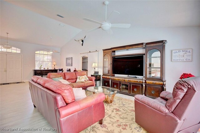 living room with ceiling fan and lofted ceiling