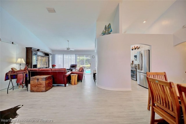 interior space with ceiling fan, light hardwood / wood-style floors, and vaulted ceiling