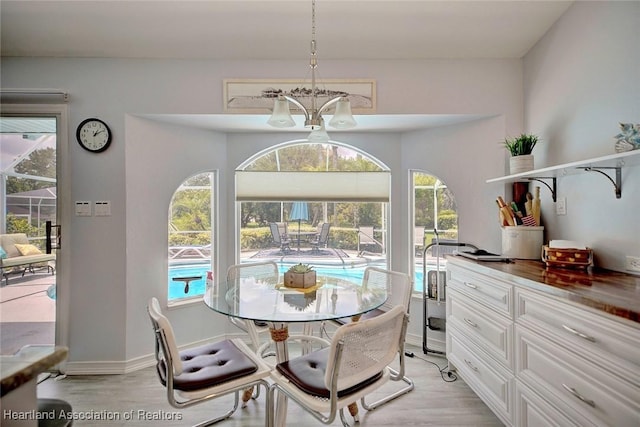 dining room with a chandelier and light hardwood / wood-style floors