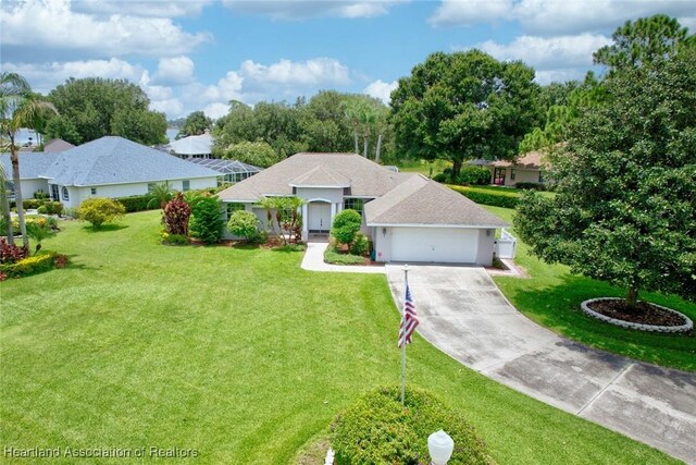 ranch-style house featuring a front yard and a garage