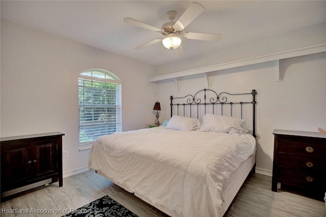 bedroom with ceiling fan and light hardwood / wood-style floors