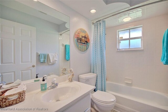 full bathroom featuring vanity, toilet, and shower / bath combo with shower curtain