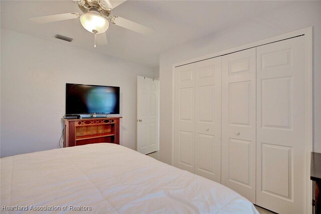 bedroom with ceiling fan and a closet