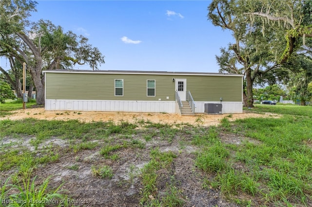 317 Old Bradenton Rd, Wauchula, FL 33873 - rear view of property featuring entry steps and central AC