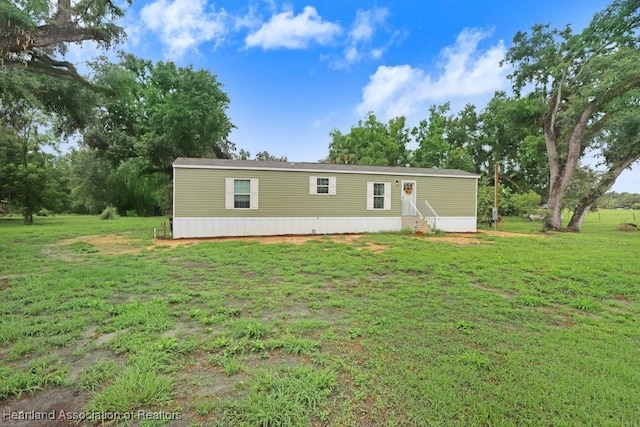 317 Old Bradenton Rd, Wauchula, FL 33873 - back of property with entry steps and a lawn