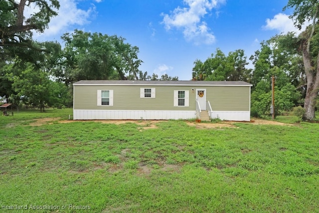 317 Old Bradenton Rd, Wauchula, FL 33873 - manufactured / mobile home with entry steps and a front lawn