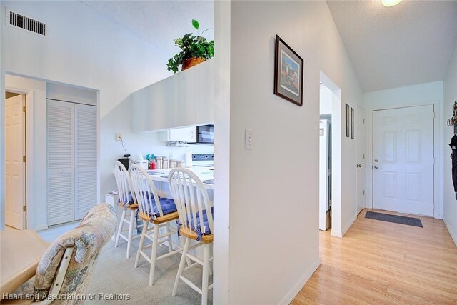 808 Chelsee Way, Lake Placid, FL 33852 - corridor with light wood-style floors and lofted ceiling