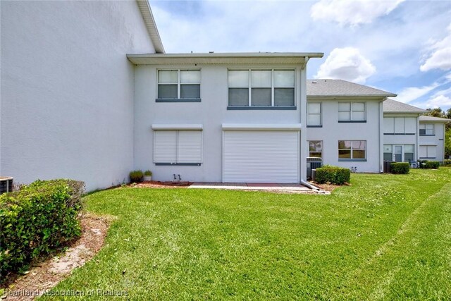 808 Chelsee Way, Lake Placid, FL 33852 - rear view of property with stucco siding and a yard