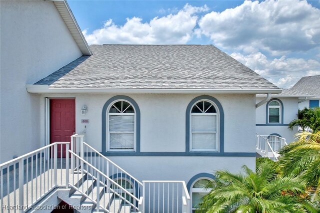 808 Chelsee Way, Lake Placid, FL 33852 - view of front of house with a shingled roof and stucco siding