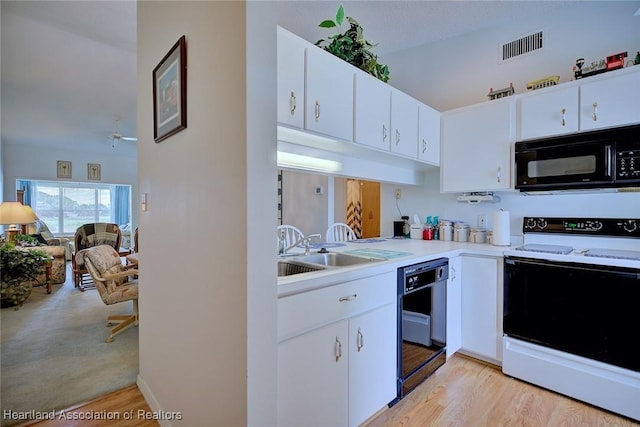 808 Chelsee Way, Lake Placid, FL 33852 - kitchen with black appliances, light countertops, white cabinetry, light wood-style flooring, and a ceiling fan