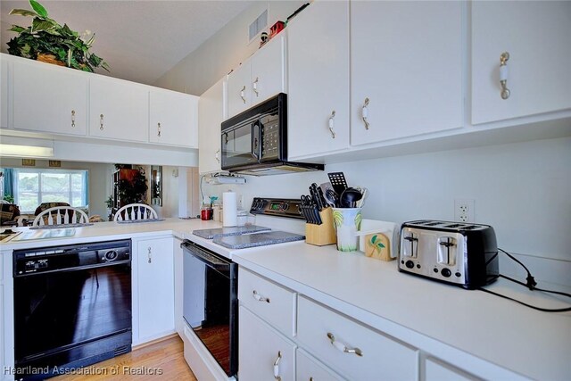 808 Chelsee Way, Lake Placid, FL 33852 - kitchen with black appliances, light countertops, white cabinetry, and light wood finished floors