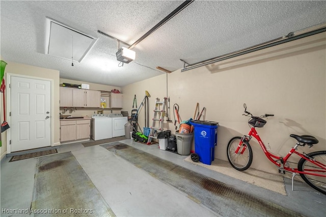 garage with washer and dryer and a garage door opener