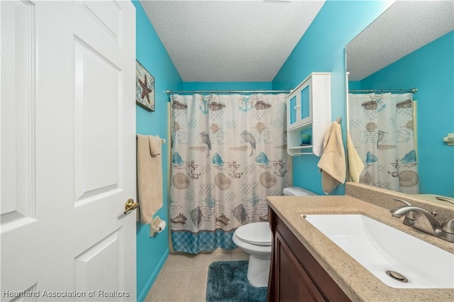 bathroom featuring tile patterned floors, vanity, a textured ceiling, and toilet