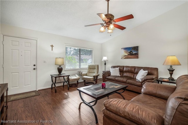 living room featuring vaulted ceiling, ceiling fan, and dark wood-type flooring