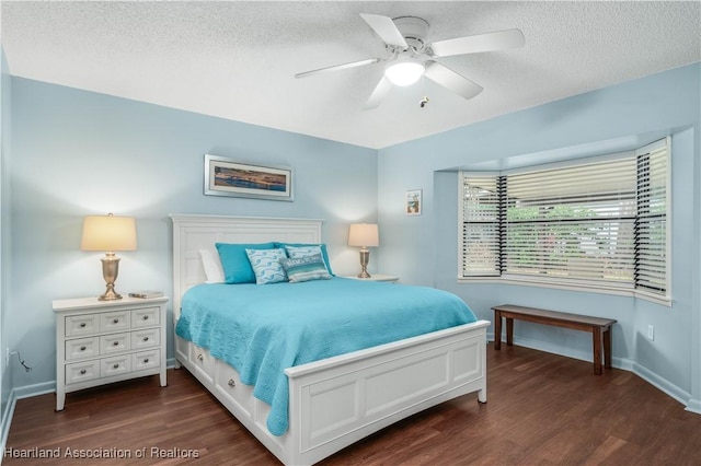 bedroom with a textured ceiling, ceiling fan, and dark wood-type flooring