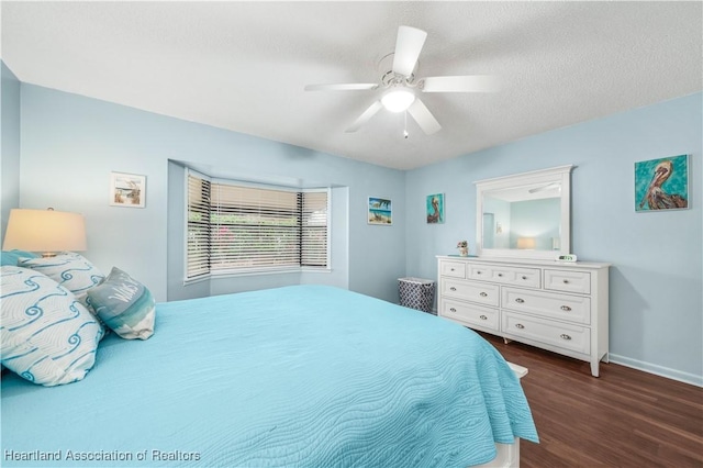 bedroom with a textured ceiling, dark hardwood / wood-style flooring, and ceiling fan