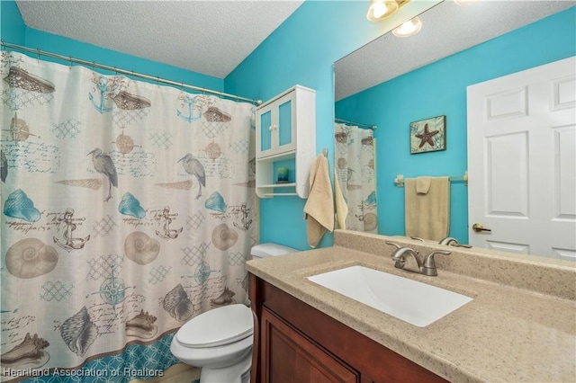 bathroom with vanity, a shower with shower curtain, a textured ceiling, and toilet