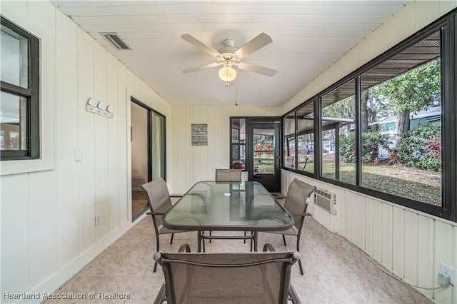 sunroom featuring ceiling fan and a wall unit AC