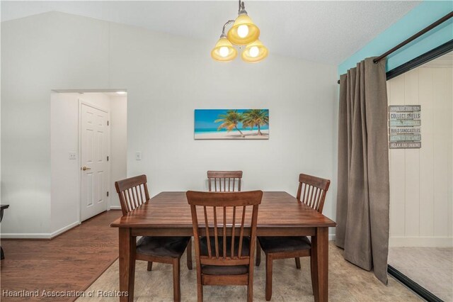 dining area featuring lofted ceiling