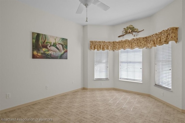 unfurnished room featuring ceiling fan and light colored carpet
