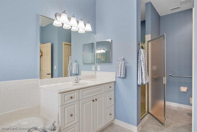 bathroom with tile patterned flooring, independent shower and bath, and vanity