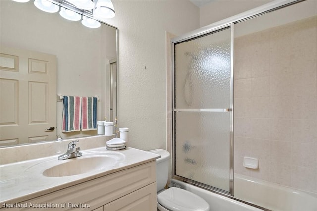 full bathroom with toilet, vanity, and combined bath / shower with glass door